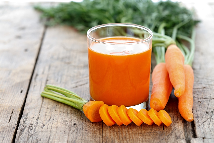 Fresh smoothie with carrots on a wooden table